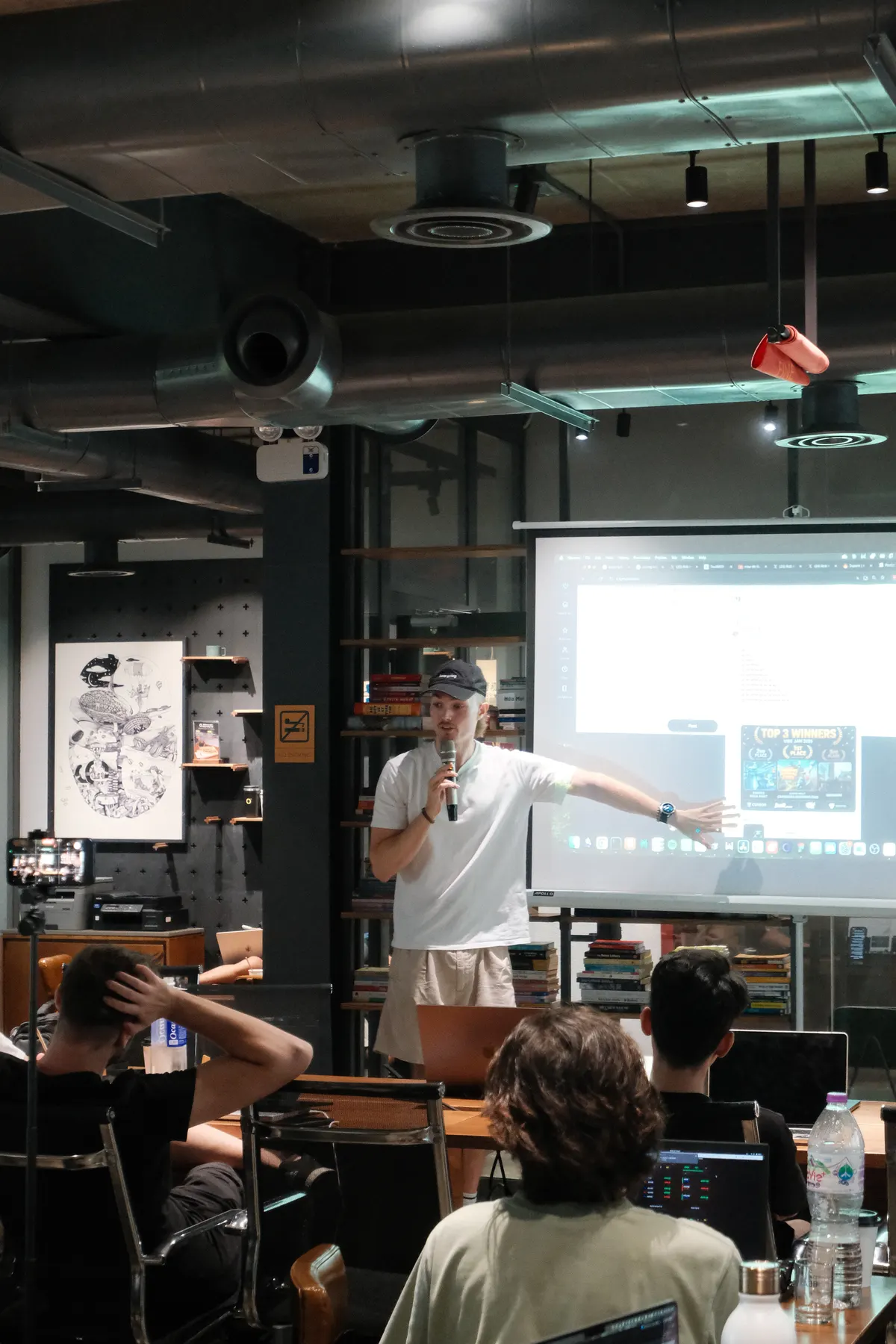 A speaker presenting at a Frontier Club AI Meetup